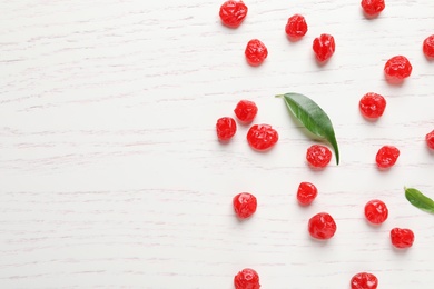 Photo of Tasty cherries on wooden background, flat lay with space for text. Dried fruits as healthy food