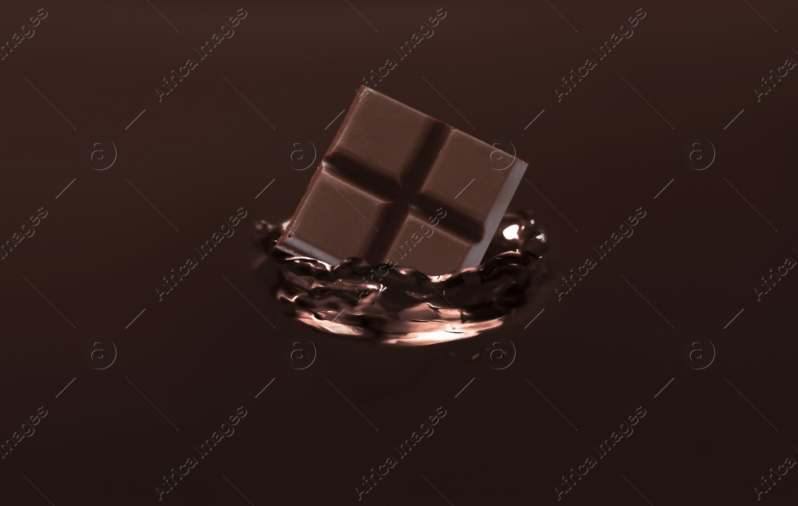 Image of Yummy melted chocolate with falling pieces as background