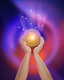 Image of Man holding concentrated healing energy in his hands, closeup