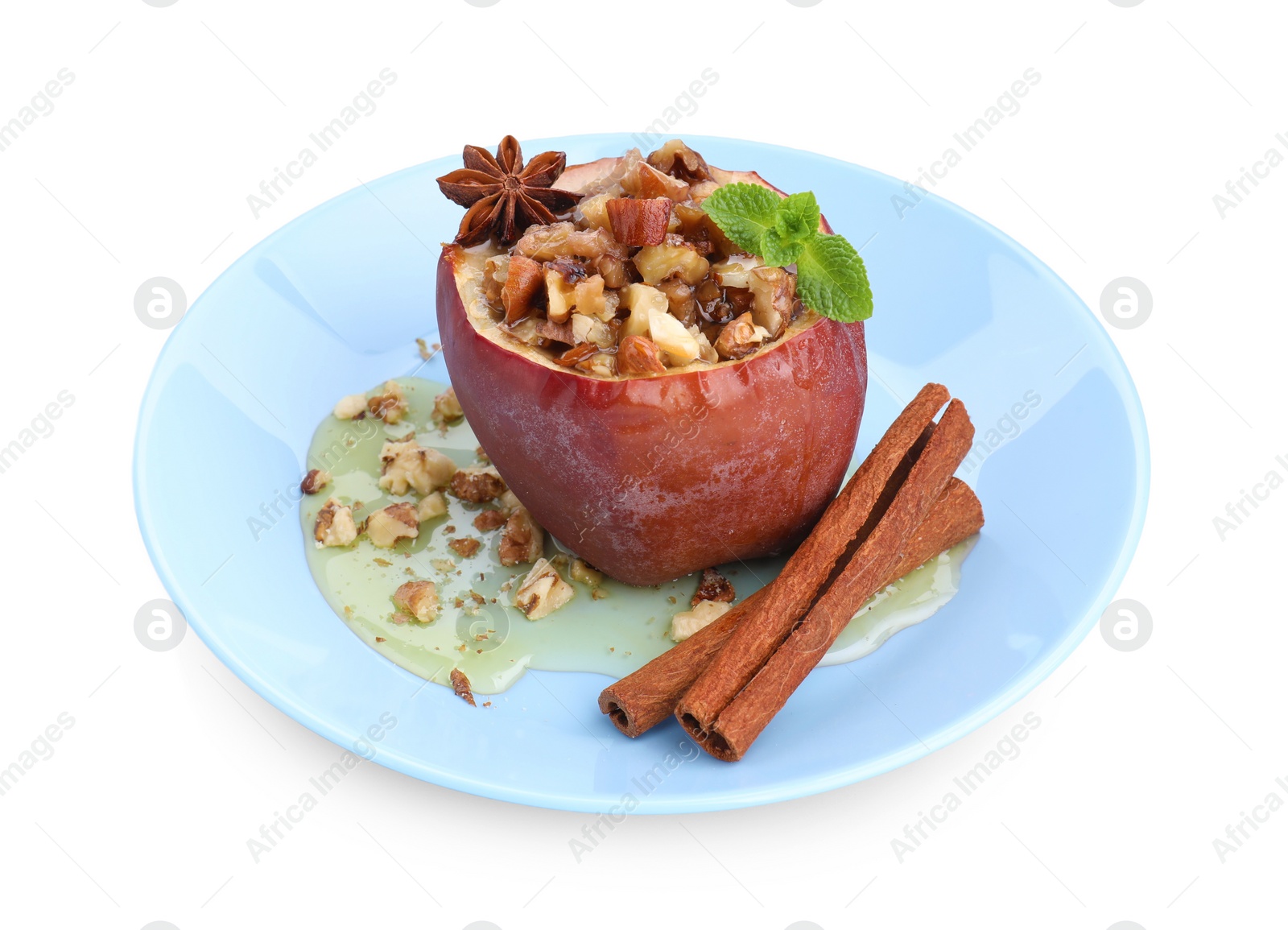 Photo of Tasty baked apple with nuts, honey, spices and mint isolated on white