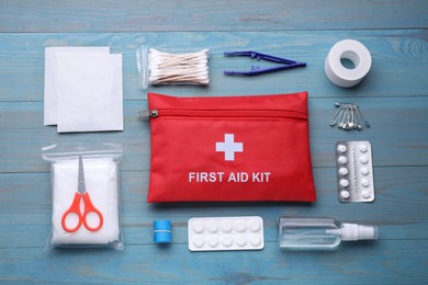 Flat lay composition with first aid kit on blue wooden table