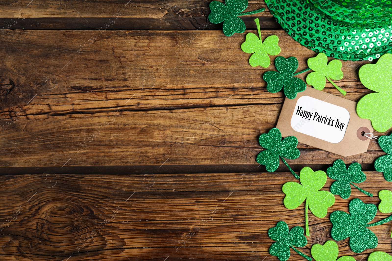 Photo of Flat lay composition with clover leaves on wooden table, space for text. St. Patrick's Day celebration