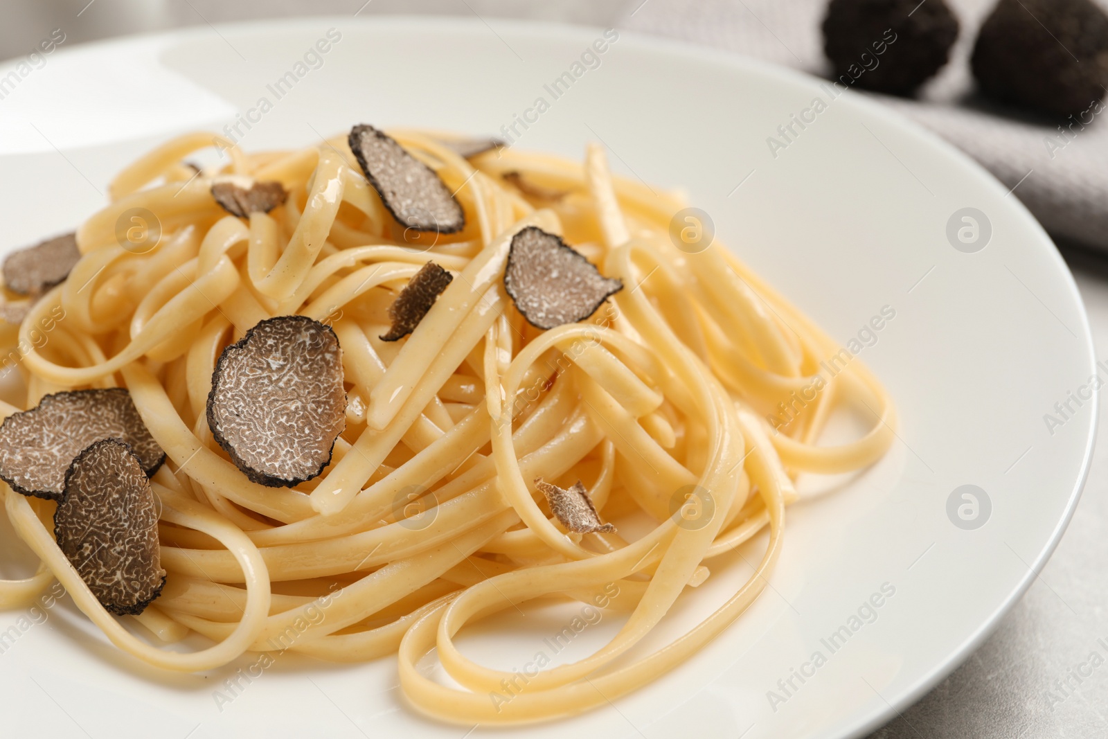 Photo of Tasty fettuccine with truffle on plate, closeup