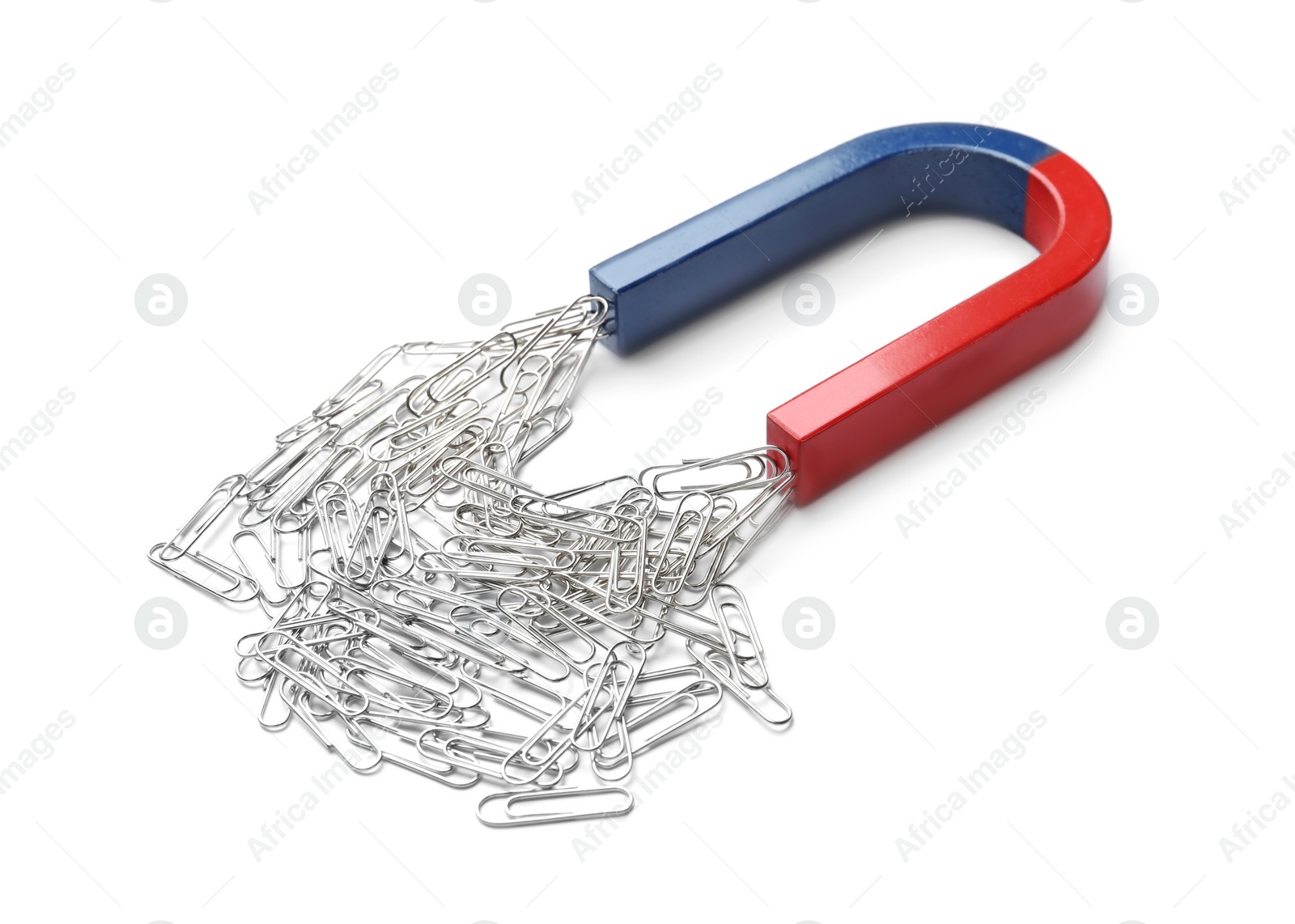 Photo of Magnet attracting paper clips on white background