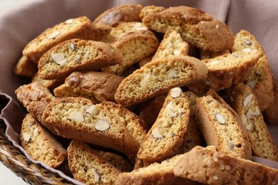 Photo of Traditional Italian almond biscuits (Cantucci) in basket, closeup