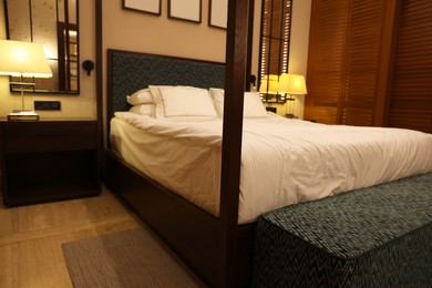 Photo of Large bed and lamps in comfortable hotel room