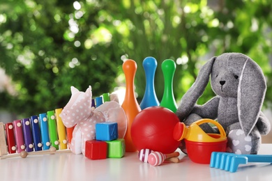 Photo of Set of different toys on table against blurred background