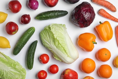 Flat lay composition with ripe fruits and vegetables on white background