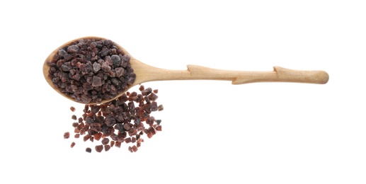 Black salt in wooden spoon on white background, top view