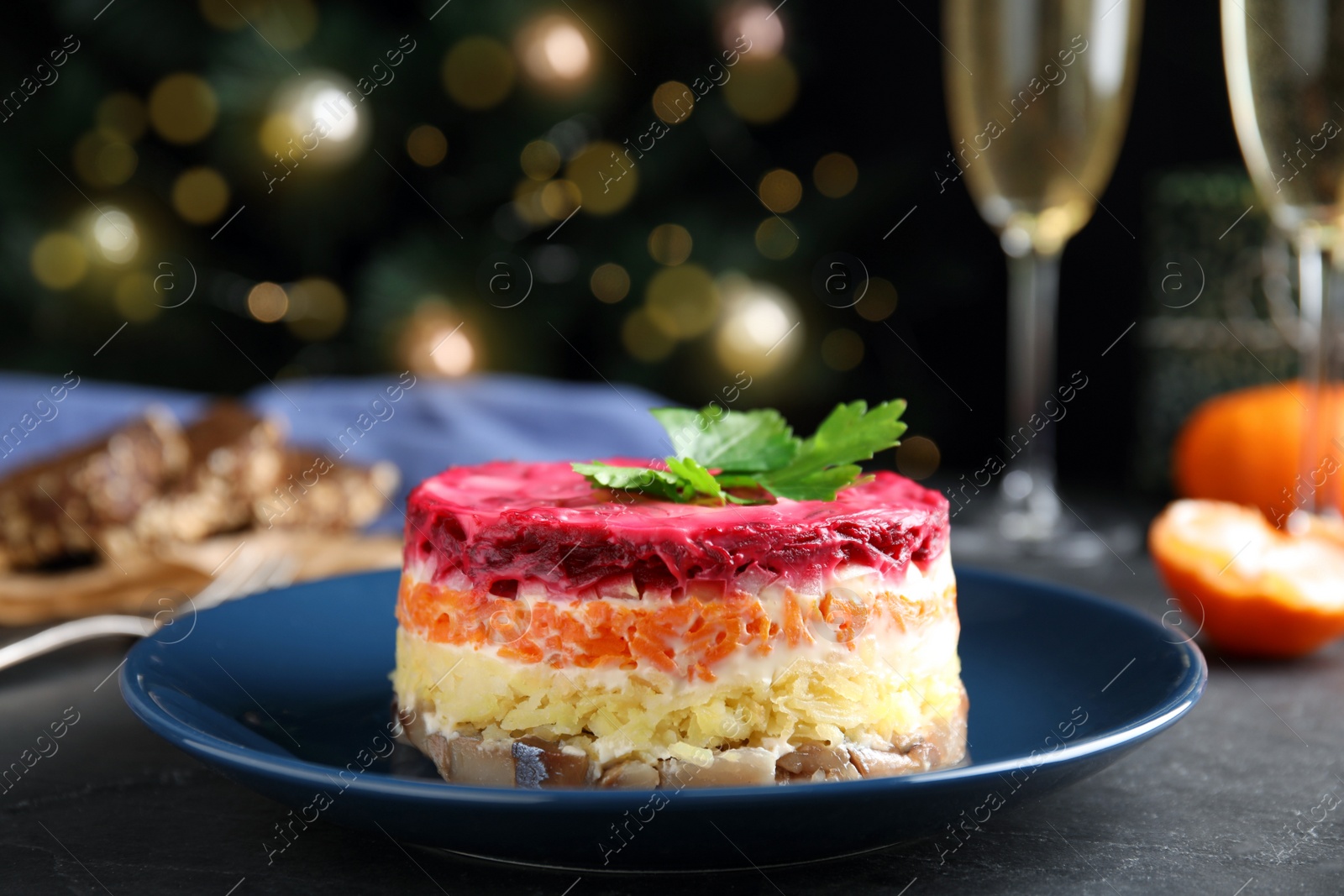 Photo of Herring under fur coat served on dark table, space for text. Traditional russian salad