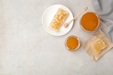 Photo of Flat lay composition with fresh honey on gray background