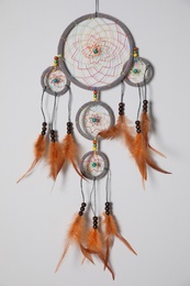Photo of Beautiful dream catcher hanging on white wall