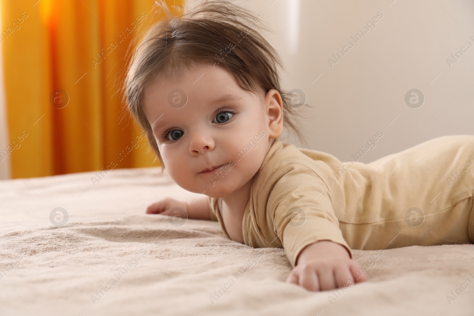 Photo of Portrait of cute little baby on bed indoors