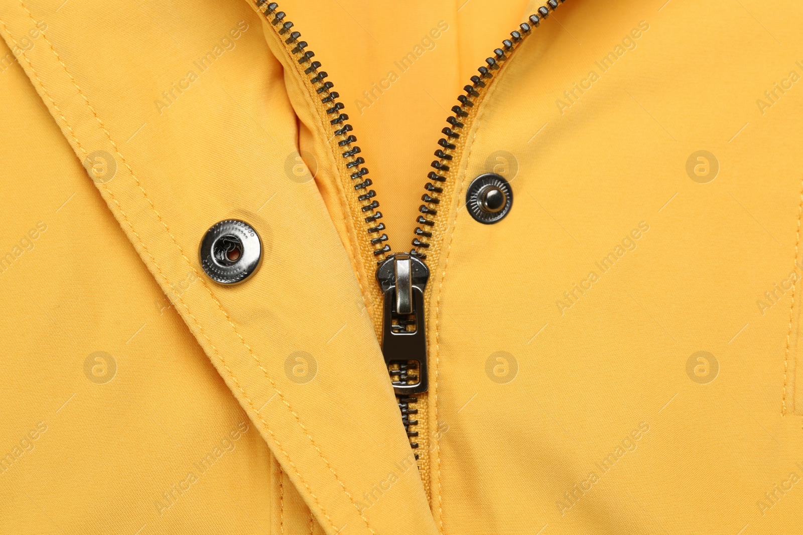 Photo of Yellow jacket with zipper as background, top view