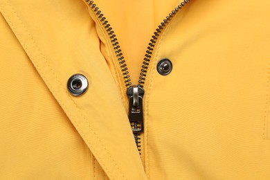 Photo of Yellow jacket with zipper as background, top view