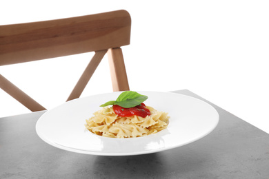 Photo of Delicious farfalle pasta with tomato sauce served on grey table