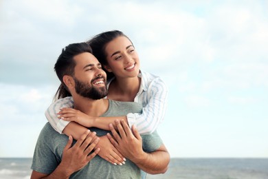 Lovely couple spending time together near sea