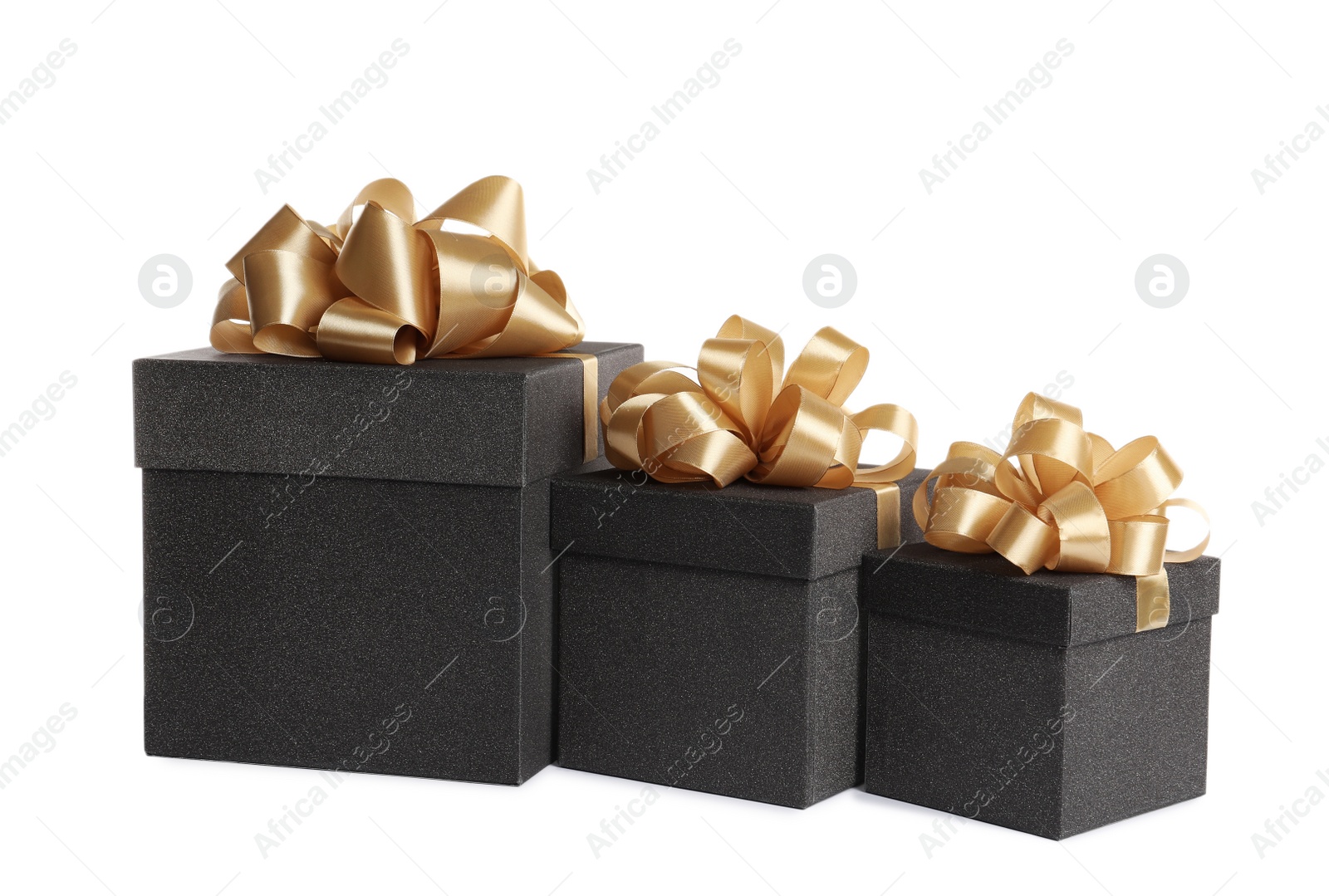 Photo of Black gift boxes with golden bows on white background