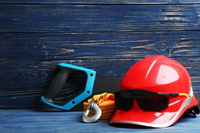 Photo of Composition with construction tools on table against wooden background, space for text