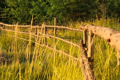 Photo of Picturesque view of countryside with wooden fence in morning