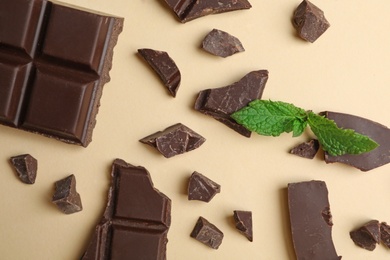 Photo of Flat lay composition with chocolate and mint on color background