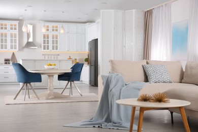 Photo of Stylish studio apartment interior with comfortable beige sofa