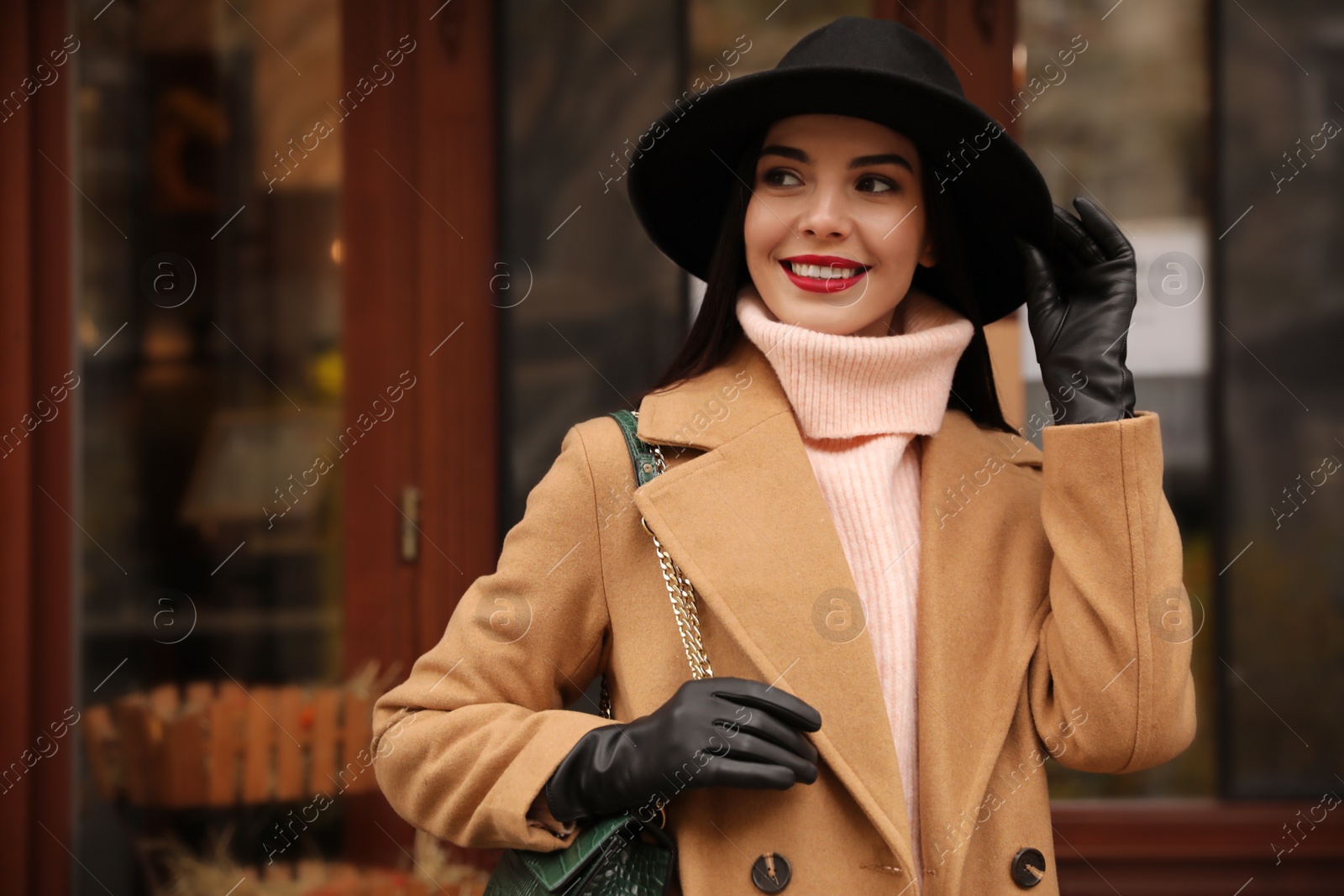 Photo of Young woman wearing stylish clothes on city street, space for text. Autumn look