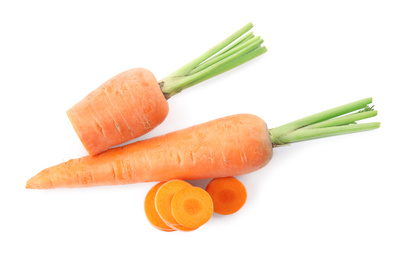 Whole and cut ripe carrots isolated on white, top view