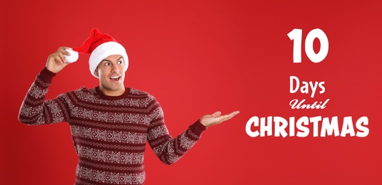 Christmas countdown. Surprised man wearing Santa hat on red background near text