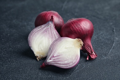 Ripe red onions on table