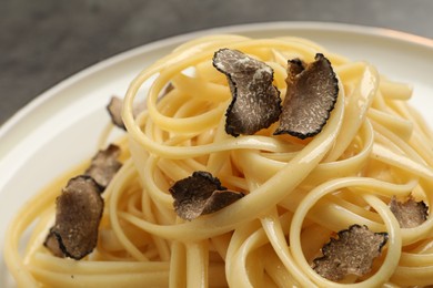 Tasty fettuccine with truffle on plate, closeup