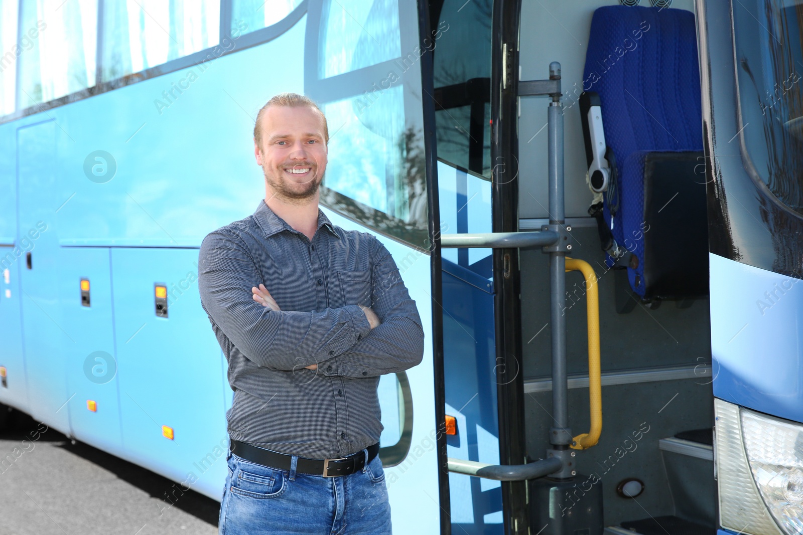 Photo of Professional driver standing near bus. Passenger transportation