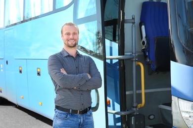 Photo of Professional driver standing near bus. Passenger transportation
