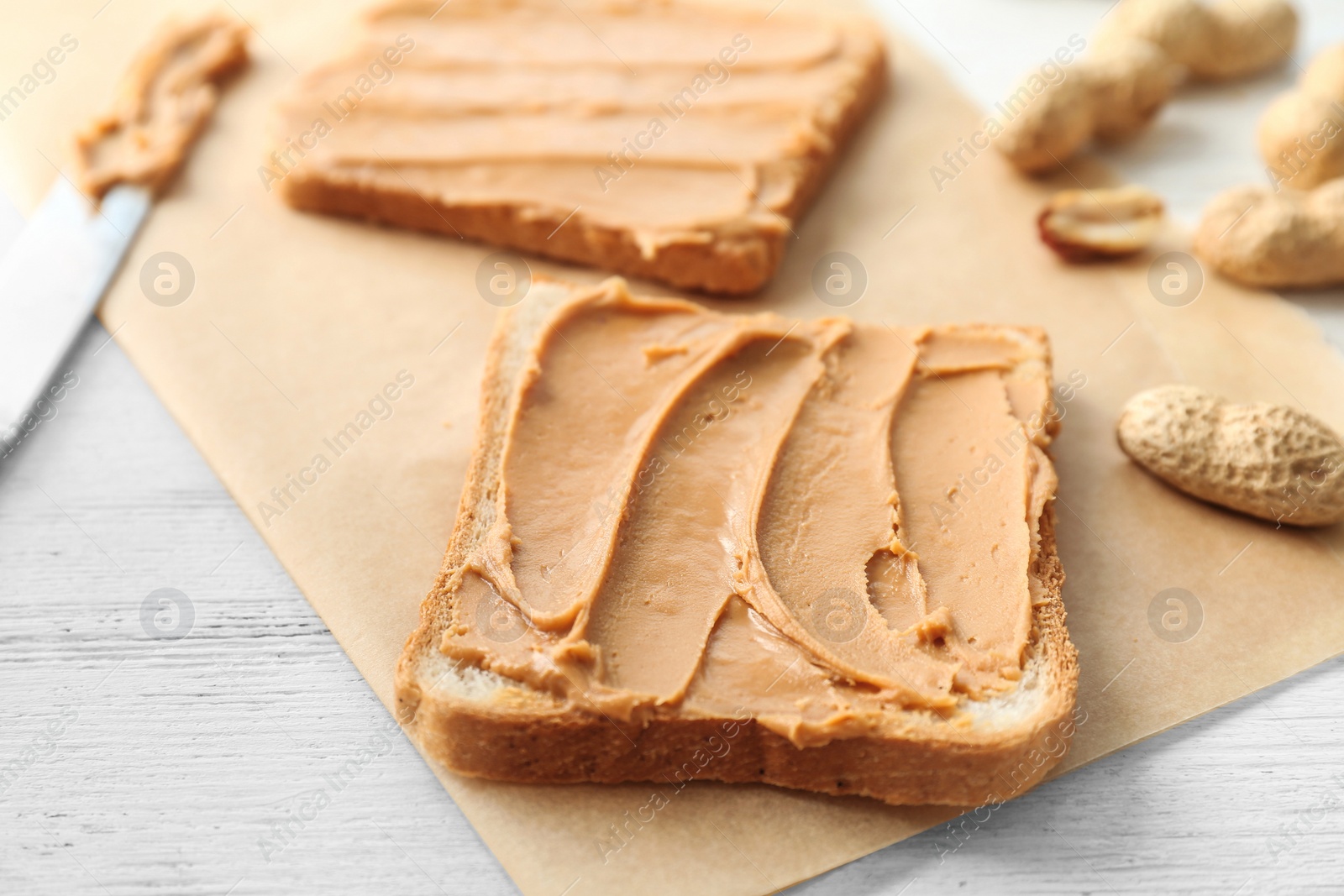 Photo of Tasty toasts with peanut butter on table