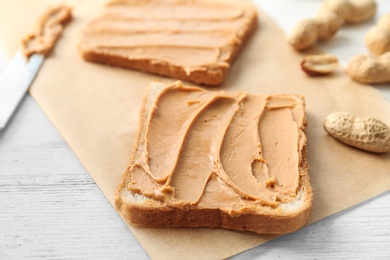 Photo of Tasty toasts with peanut butter on table