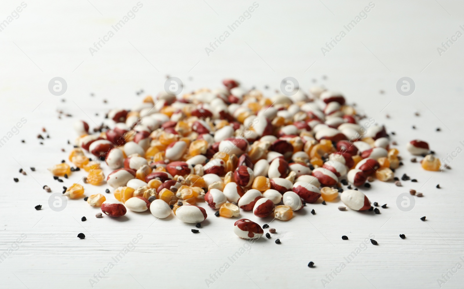 Photo of Mixed vegetable seeds on white wooden background