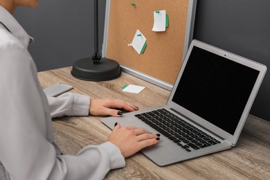 Woman using laptop at table, closeup. Stylish workplace