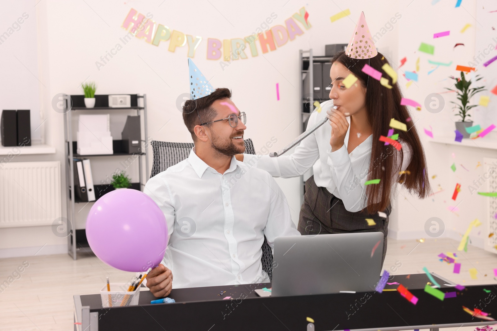 Photo of Coworkers having fun during office party indoors