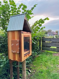 Wooden book box in garden. Free library