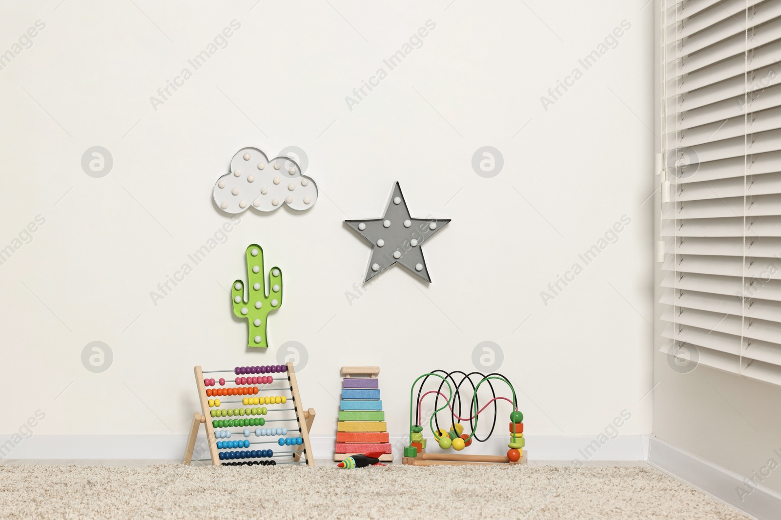 Photo of Educational toys and nightlights in beautiful children's room. Space for text