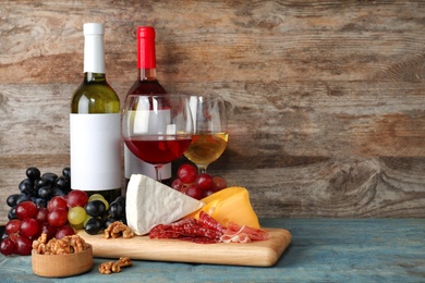 Photo of Composition with wine and snacks on table. Space for text