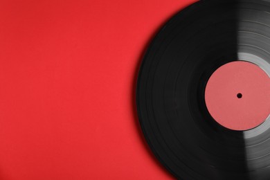 Vintage vinyl record on red background, top view. Space for text