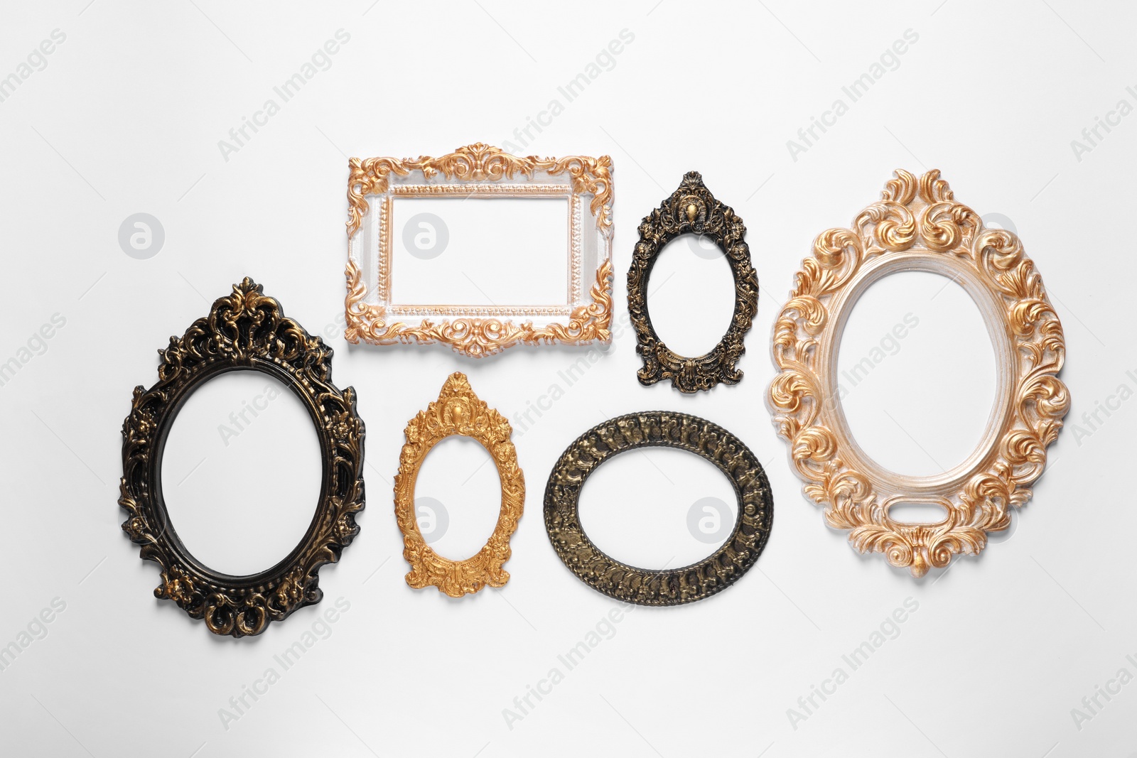 Photo of Blank vintage frames hanging on white wall