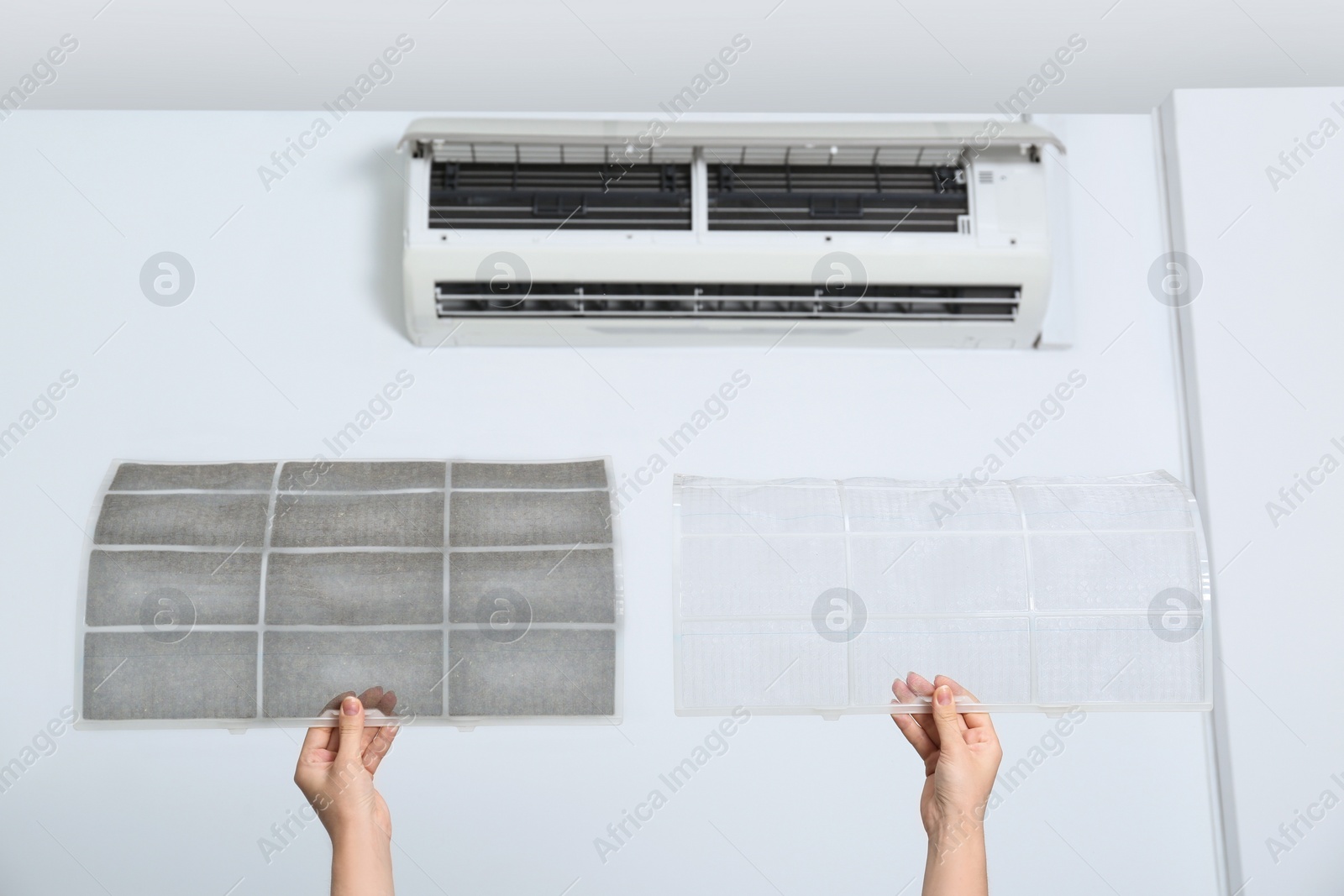 Image of Woman holding dirty and clean filters, closeup. Home air conditioner cleaning