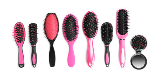 Photo of Set of modern hair brushes isolated on white, top view