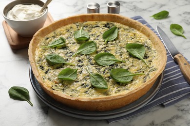 Photo of Delicious homemade spinach pie on white marble table