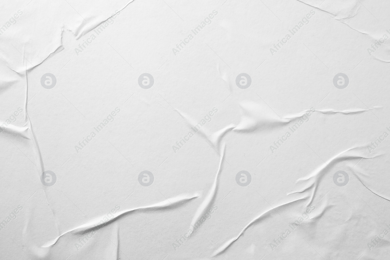 Photo of Texture of white creased paper, closeup view