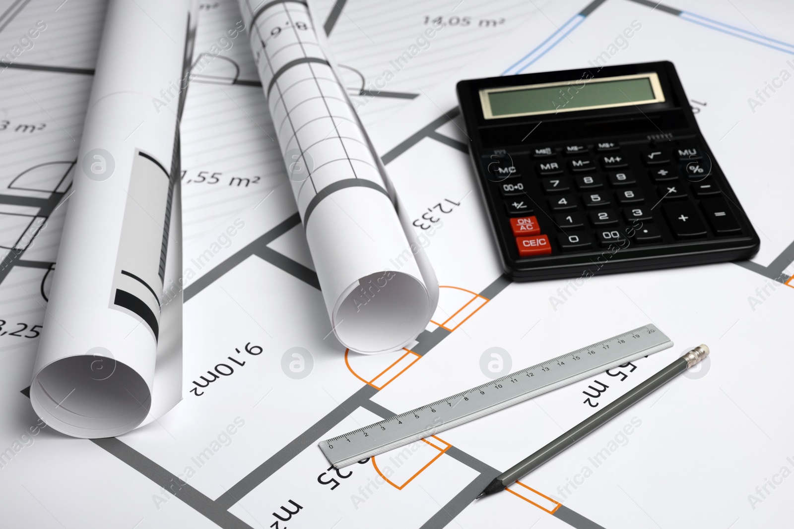 Photo of Construction drawings, ruler, pencil and calculator on house plan. Architect workspace