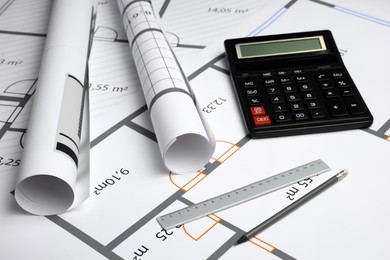 Construction drawings, ruler, pencil and calculator on house plan. Architect workspace