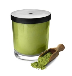Jar and scoop with powdered matcha tea on white background